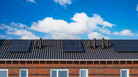 Photo for Newly built houses with solar panels attached on the roof - Royalty Free Image