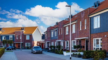Photo for Dutch Suburban area with modern family houses, street with modern family homes in the Netherlands - Royalty Free Image
