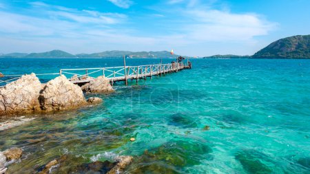 Photo for Wooden pier jetty at Ko Kham Island Sattahip Chonburi Samaesan Thailand a tropical island with turqouse colored ocean on a sunny day - Royalty Free Image