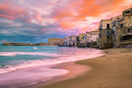 Photo for Sunset at the beach of Cefalu Sicily, an old town of Cefalu Sicilia panoramic view of the colorful village.Italy, sunset during storm weather in Sicily - Royalty Free Image