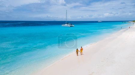 Klein Curazao Island with Tropical white beach at the Caribbean island of Curacao Caribbean, a couple of men and women on a boat trip to Small Curacao Island looking at the turqouse colored ocean