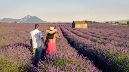 Photo for A colorful field of Lavender at the Valensole Plateau Provence Southern France, a couple of men and women on summer vacation in France. Provence Lavender Field France Valensole Plateau - Royalty Free Image
