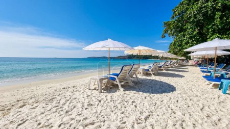 Téléchargez les photos : Koh Samet Island Rayong Thaïlande, chaises de plage transat avec parasols à la plage tropicale blanche de Samed Island avec un océan de couleur turque et un ciel bleu - en image libre de droit