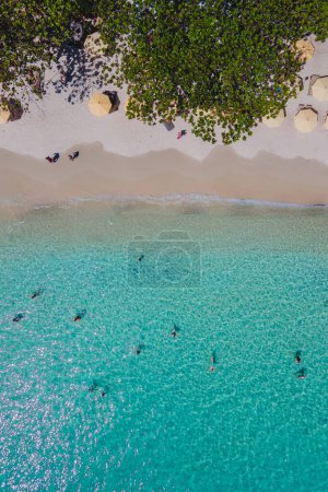Photo for People swimming in the ocean during vacation at Koh Samet Island Thailand, aerial drone view from above at the Samed Island in Thailand with a turqouse colored ocean - Royalty Free Image