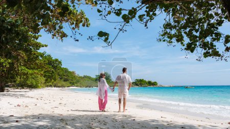 Photo for A couple of men and woman walking on the beach of Koh Samet Island Rayong Thailand - Royalty Free Image