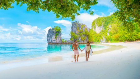 Photo for Koh Hong Island Krabi Thailand, a couple of men and women on the beach of Koh Hong during vacation in Thailand, a tropical white beach with Asian women and European men in Krabi Thailand - Royalty Free Image