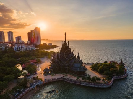 Photo for Skyline of Pattaya city at sunset with The Sanctuary of Truth wooden temple in Pattaya Thailand, sunset over the wooden temple in Pattaya Thailand by the ocean - Royalty Free Image