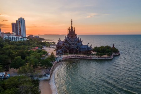 Photo for The Sanctuary of Truth wooden temple in Pattaya Thailand at sunset by the ocean, a gigantic wooden construction located at the cape of Naklua Pattaya City Chonburi Thailand - Royalty Free Image