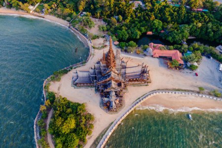 Photo for The Sanctuary of Truth wooden temple in Pattaya Thailand is a gigantic wooden construction located at the cape of Naklua Pattaya City Chonburi Thailand at sunset dusk - Royalty Free Image