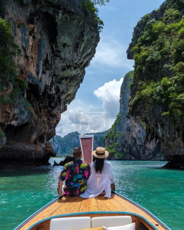 Photo for Luxury Longtail boat in Krabi Thailand, couple man and woman on a trip to the tropical island 4 Island in Krabi Thailand. Asian woman and European man mid age on vacation in Thailand. - Royalty Free Image