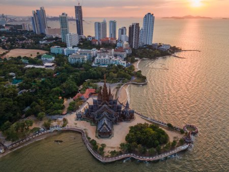 Photo for Skyline of Pattaya city at sunset with The Sanctuary of Truth wooden temple in Pattaya Thailand - Royalty Free Image