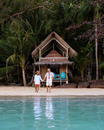 Photo for Koh Wai Island Trat Thailand is a tinny tropical Island near Koh Chang. wooden bamboo hut bungalow on the beach. a young couple of men and woman on a tropical Island in Thailand in the evening - Royalty Free Image