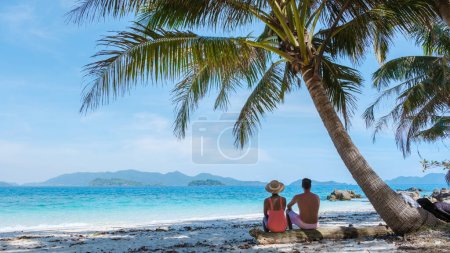 Photo for Koh Wai Island Trat Thailand near Koh Chang. a young couple of men and women on a tropical beach during a luxury vacation in Thailand, men and woman relaxing under a palm tree at a natural beach - Royalty Free Image