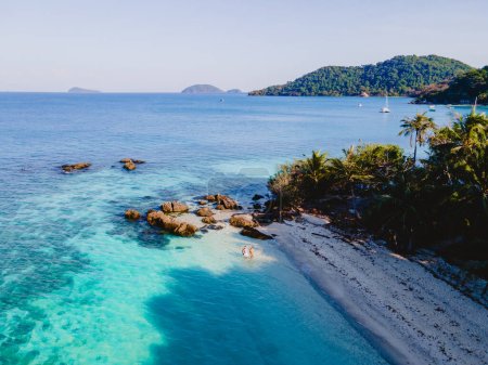 Photo for Drone aerial view at Koh Wai Island Trat Thailand is a tinny tropical Island near Koh Chang. A young couple of men and women walking on a tropical beach during a luxury vacation in Thailand - Royalty Free Image