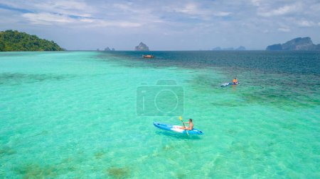 Photo for Young men in a kayak at the bleu turqouse colored ocean of Koh Kradan a tropical island with a coral reef in the ocean, Koh Kradan Trang Thailand - Royalty Free Image