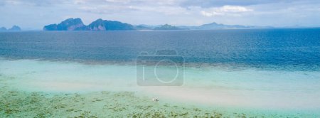 Photo for Aerial view at Koh Kradan a tropical island with palm trees soft white sand, and a turqouse colored ocean in Koh Kradan Trang Thailand at sunset - Royalty Free Image