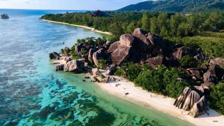 Drone top view at Anse Source d'Argent beach La Digue Island Seychelles, Drone aerial view of La Digue Seychelles, tropical vacation summer holiday, a beach with huge granite rocks at sunset