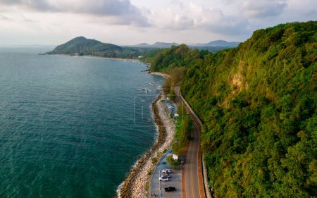 car driving on the curved road of Thailand. road landscape in summer. it's nice to drive on the beachside highway. Chantaburi Province Thailand, drone top view