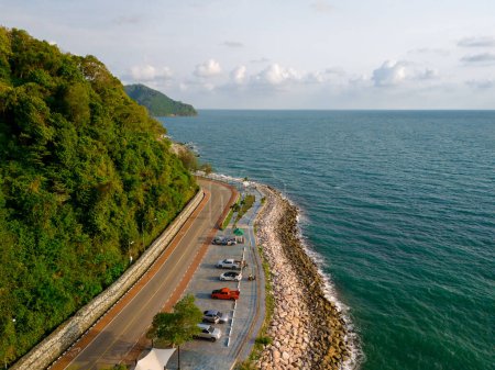 car driving on the curved road alongside the ocean beach road of Thailand. road landscape in summer. it's nice to drive on the beachside highway. Chantaburi Province Thailand, 