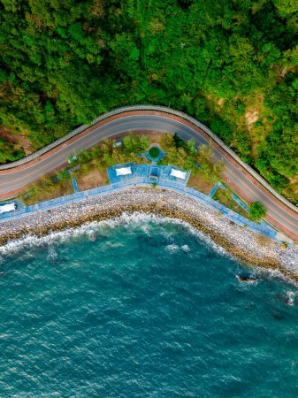 car driving on the curved road alongside the ocean beach road of Thailand. road landscape in summer. it's nice to drive on the beachside highway. Chantaburi Province Thailand, 