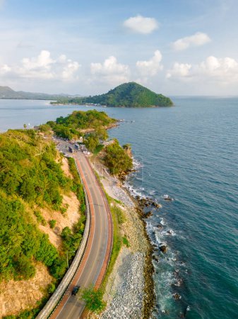 car driving on the curved road of Thailand. road landscape in summer. it's nice to drive on the beachside highway. Chantaburi Province Thailand, vertical photo