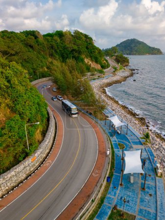 car driving on the curved road of Thailand. road landscape in summer. it's nice to drive on the beachside highway. Chantaburi Province Thailand, road trip in Thailand