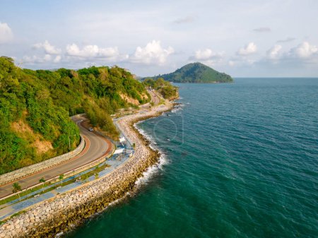 car driving on the curved road of Thailand. road landscape in summer. it's nice to drive on the beachside highway. Chantaburi Province Thailand, coastal road alongside the ocean