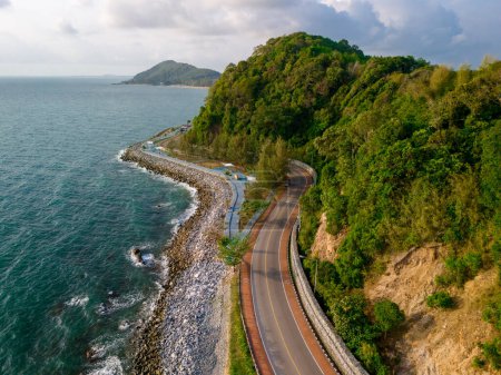 car driving on the curved road alongside the ocean beach road in summer. it's nice to drive on the beachside highway. Chantaburi Province Thailand, 