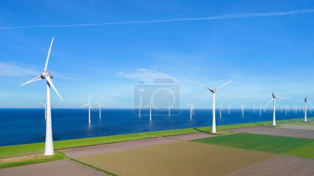 windmill park and a blue sky, windmill turbines on land and in the ocean. Netherlands Europe. windmill turbines in the Noordoostpolder Flevoland