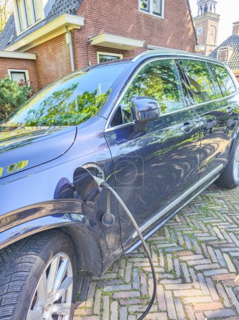 Photo for EV charging electric car , green energy and eco power produced from sustainable source to supply to charger station in order to reduce CO2 emission in the Netherlands - Royalty Free Image