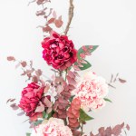 beautiful pink flowers in vase, roses and white background
