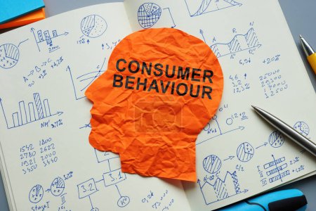 Photo for Consumer behaviour sign on the paper head and open notepad with marks. - Royalty Free Image