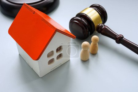 Photo for A Model of house with two figures and gavel. Separation or inheritance concept. - Royalty Free Image