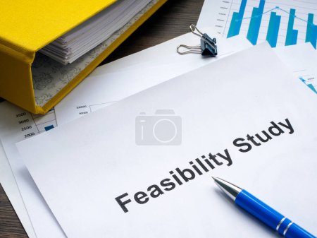 Photo for Stack of papers with feasibility study and a folder. - Royalty Free Image