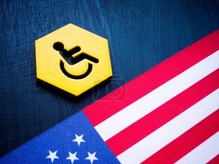 Photo for A Plate with disability person sign and the USA flag. - Royalty Free Image