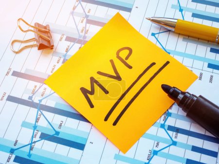 Photo for Papers with charts and a sticker with MVP Minimum Viable Product. - Royalty Free Image