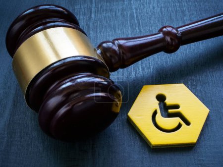 Photo for A Gavel as symbol of law and disability person sign. - Royalty Free Image
