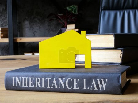 Photo for Book inheritance law and model of house on it. - Royalty Free Image