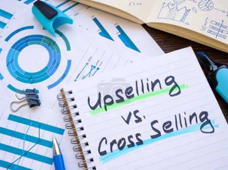Notepad with inscriptions Upselling vs Cross selling.