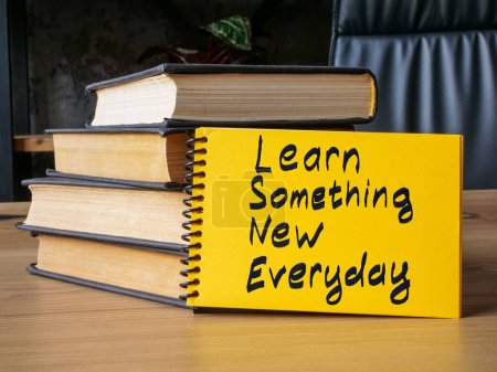 Photo for Learn something new everyday sign and books for lifelong learning. - Royalty Free Image