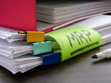 Photo for Stack of papers and sticker MRP Material requirements planning. - Royalty Free Image