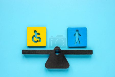 Inclusion concept. Scales with the sign of person with disabilities and an ordinary employee.