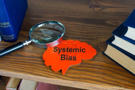 Systematic bias concept. Sign and magnifying glass on shelf.