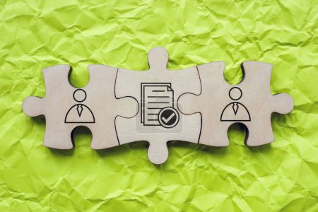 Puzzleteile mit Figuren und Kontrakt als Symbol des Verständnisses und der Übereinstimmung.