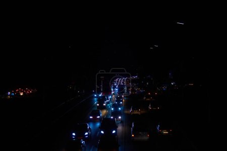 Photo for Kyiv, Ukraine - December 16, 2022: Blackout in the Ukrainian capital Kyiv. Capital streets without street lighting. Only the lights of passing cars are visible. - Royalty Free Image