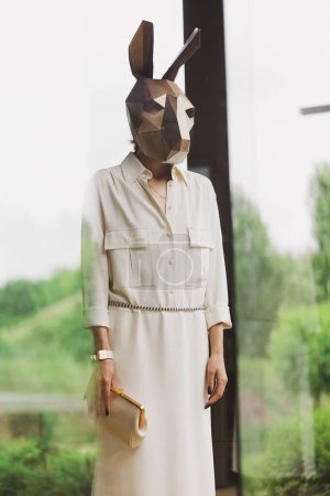 Photo for Fashionble woman in rabbit mask in the interior. - Royalty Free Image