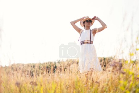 Photo for Beautiful girl in a linen dress in a wheat field. Summer vacation, traveling. Bohemian, modern hippie style. - Royalty Free Image