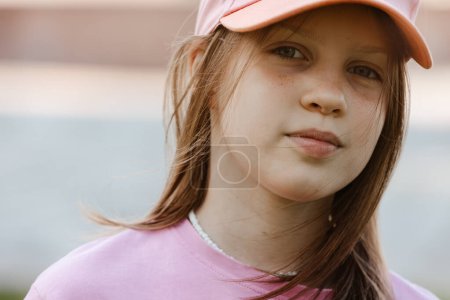 Photo for Close up portrait of a ten year old girl, smiling up at the camera. Positive emotion. - Royalty Free Image