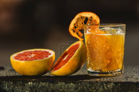 Photo for Delicious old fashion cocktail in the etched glass with ice and orange slices. Shallow dof - Royalty Free Image
