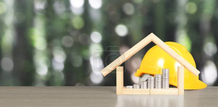 Photo for Yellow hardhat model house and coin with trading graph, financial investment concept - Royalty Free Image